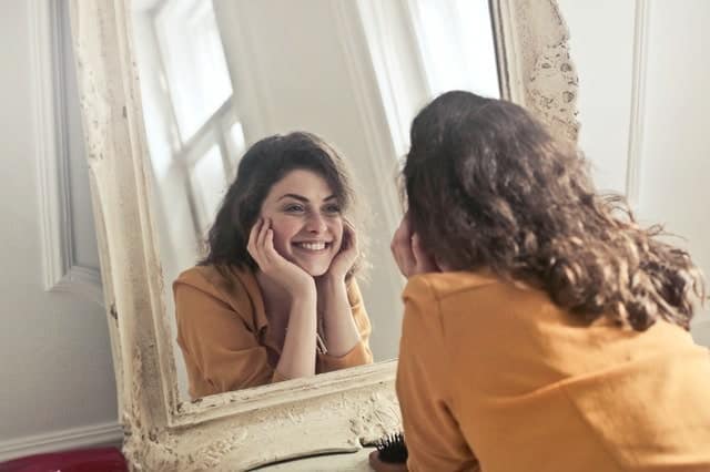 Woman Smiling in Mirror